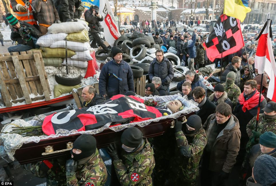 Photo:EPA  The body of Mikhail Zhiznevsky carried by opposition activists. 